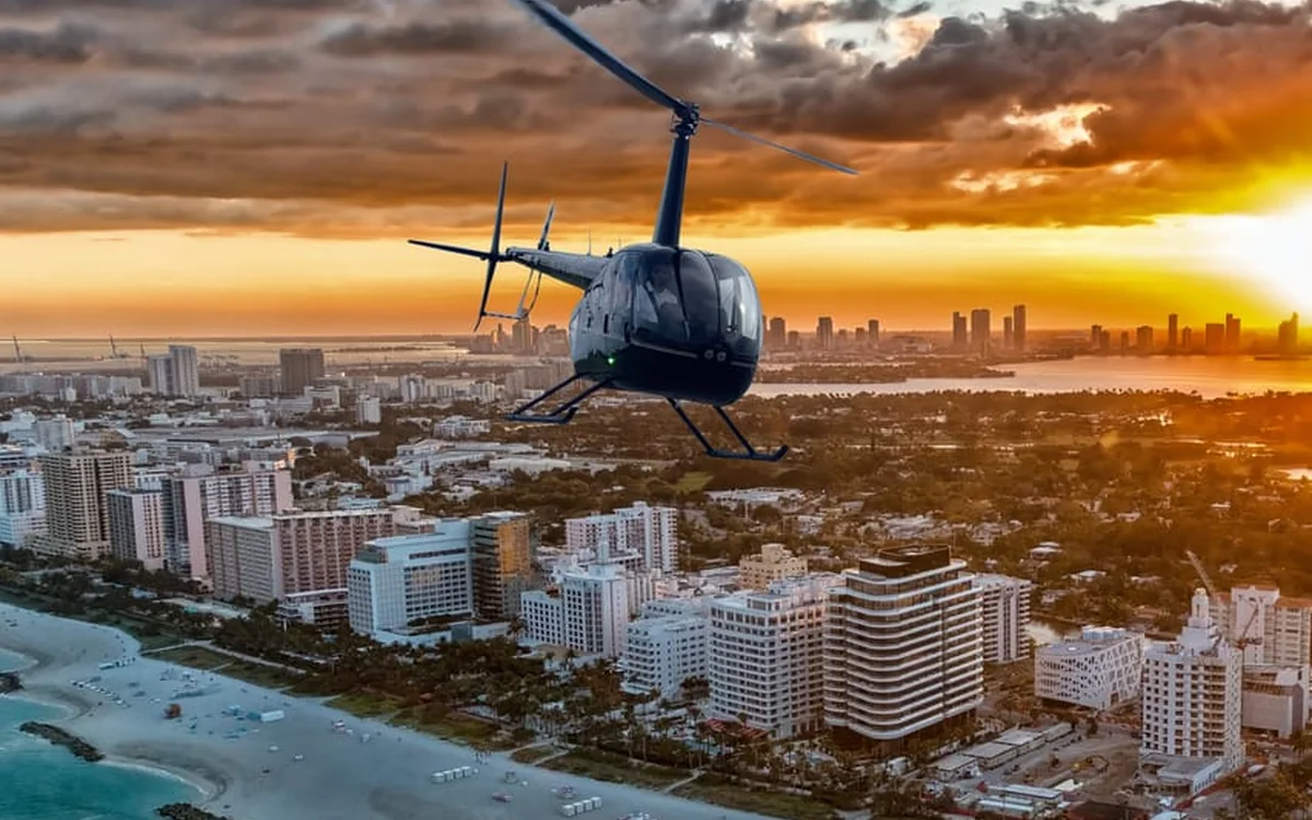 A helicopter banking over the Miami skyline and Biscayne Bay