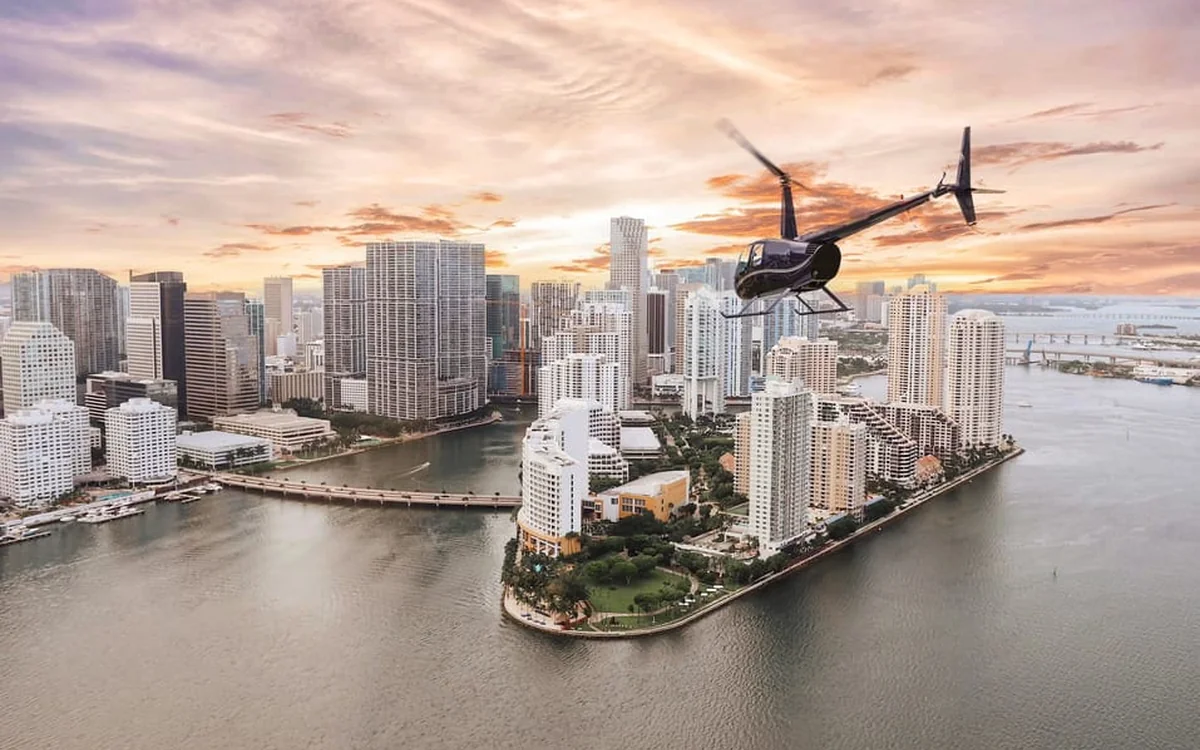 A helicopter banking low over the coastline near Miami