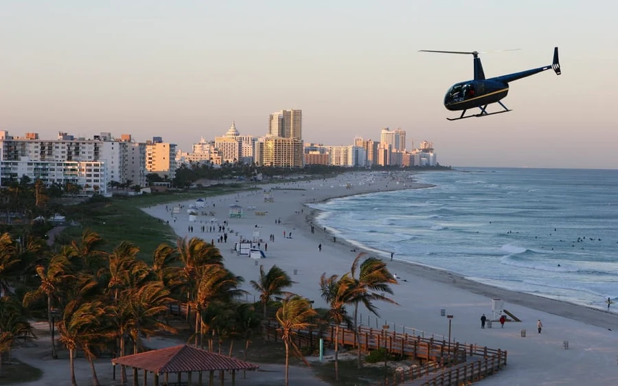 Two passengers with champagne in a private Miami helicopter
