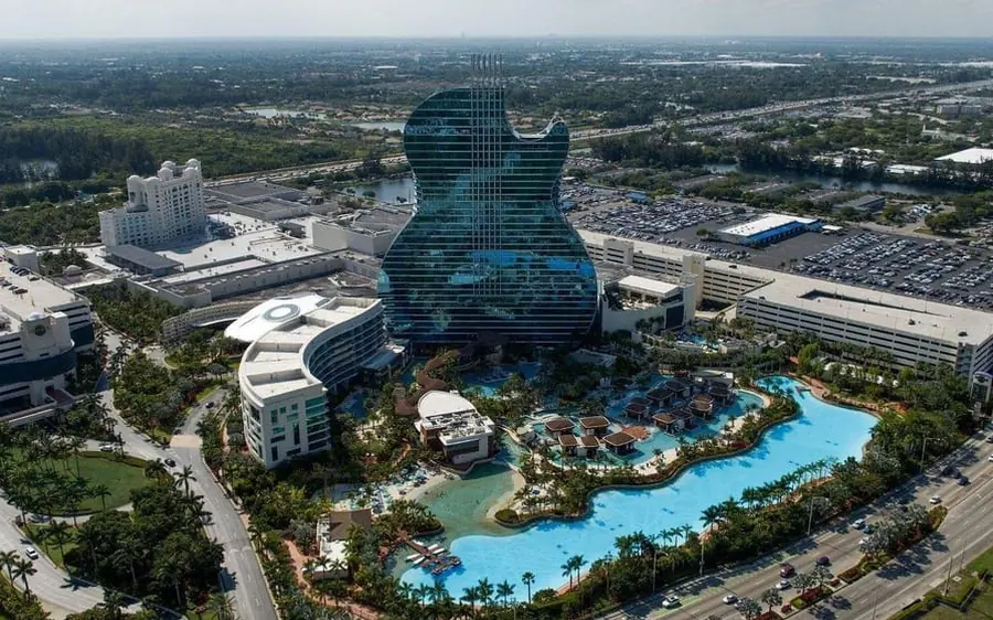 A helicopter passing the Hard Rock Stadium and the beach