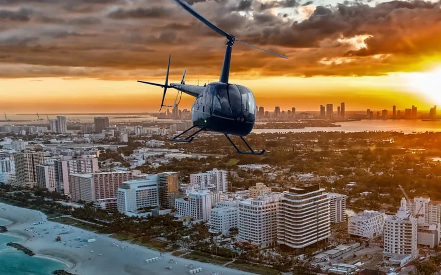 A helicopter over South Beach at sunset