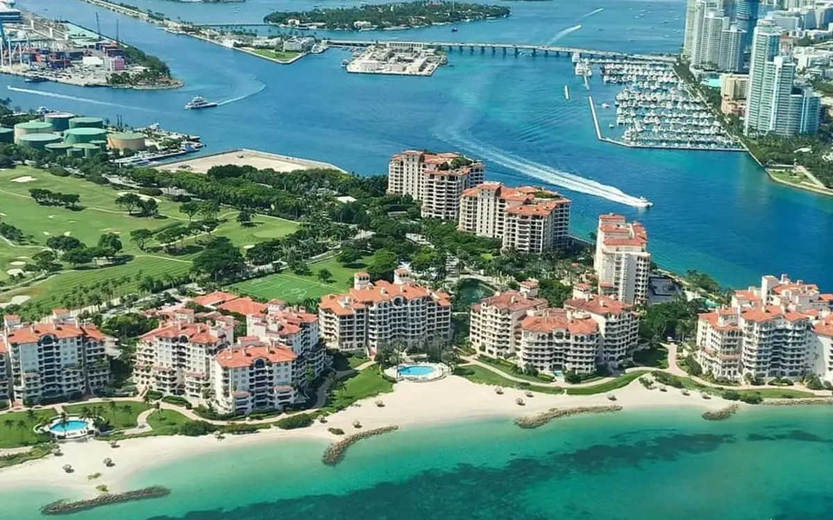 A small plane flying low over a Miami beach